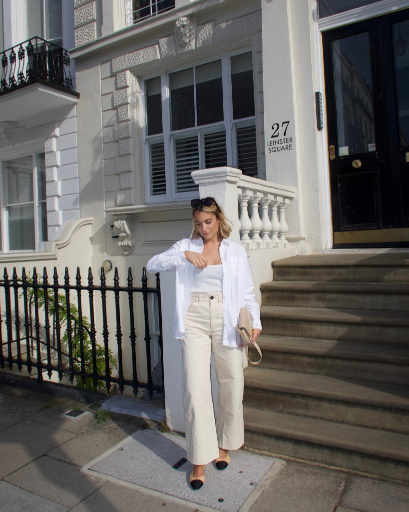 White shirt paired with wide-leg trousers.
