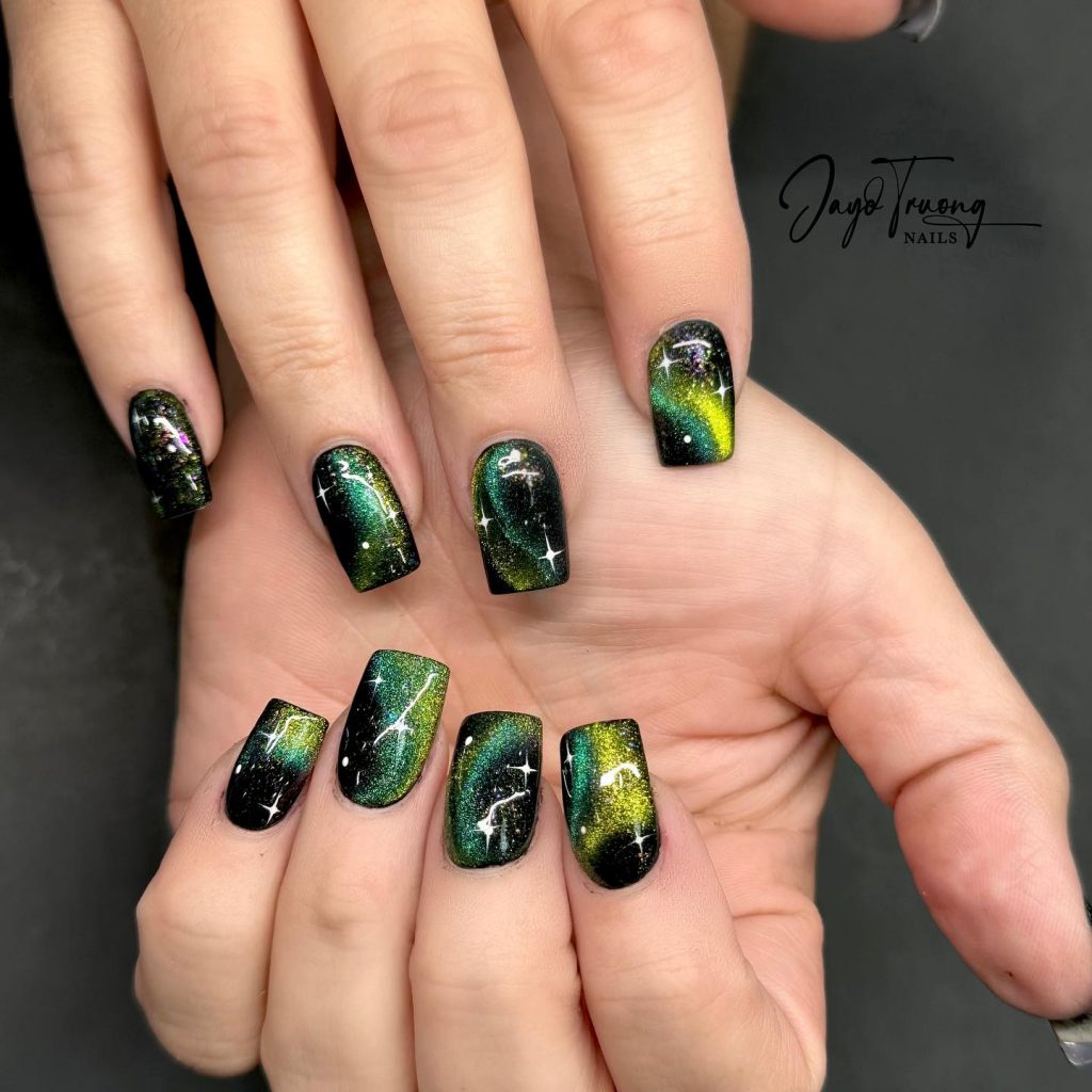 Cosmic green vibes on acrylic square nails.