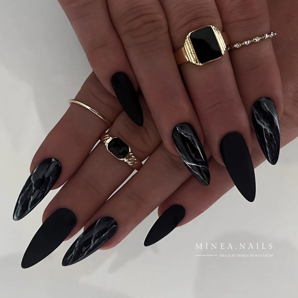 Sleek black marble nails for a modern party look.