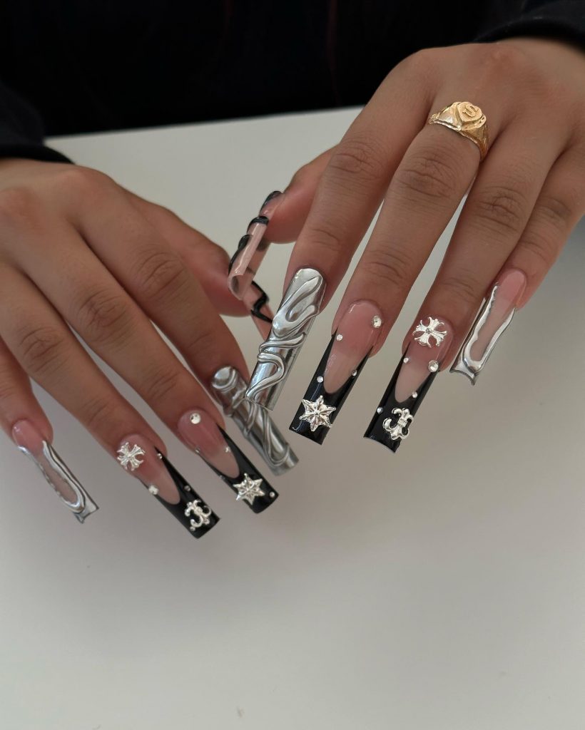 Sleek black and silver elegance on acrylic nails.