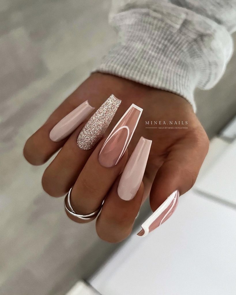 Coffin nails, nude shades, gold glitter.
