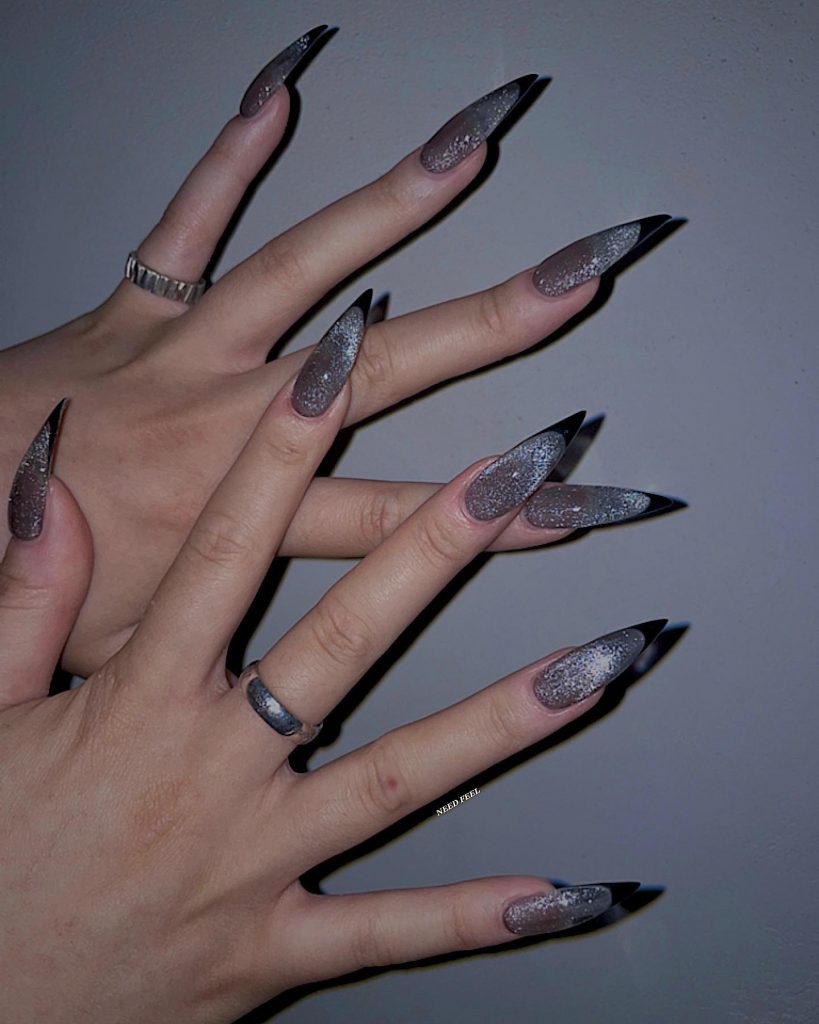 Sleek black French tip nails for a chic party look.