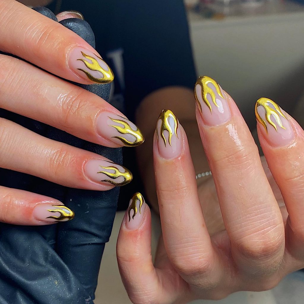 Dazzling gold flame nails to ignite your party style.