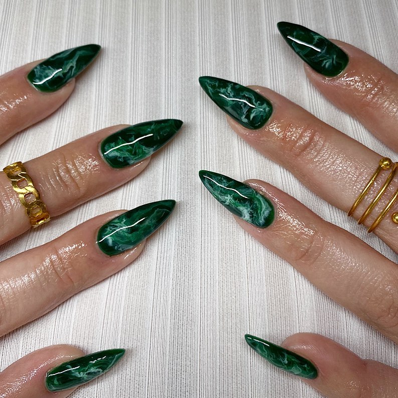 Dark nails with a touch of green smoky accents.