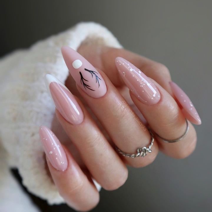Delicate white details on long almond-shaped nude nails.