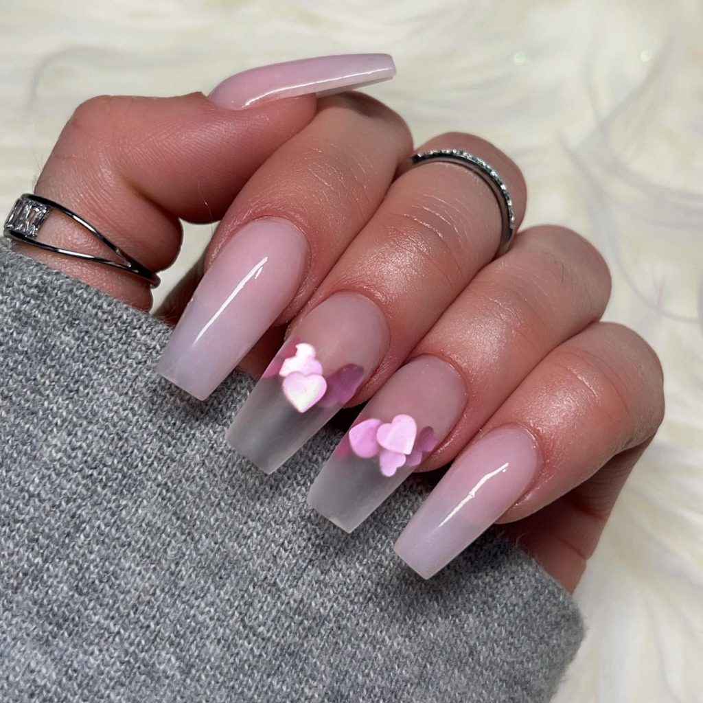 Romantic pink heart motif on acrylic coffin nails.