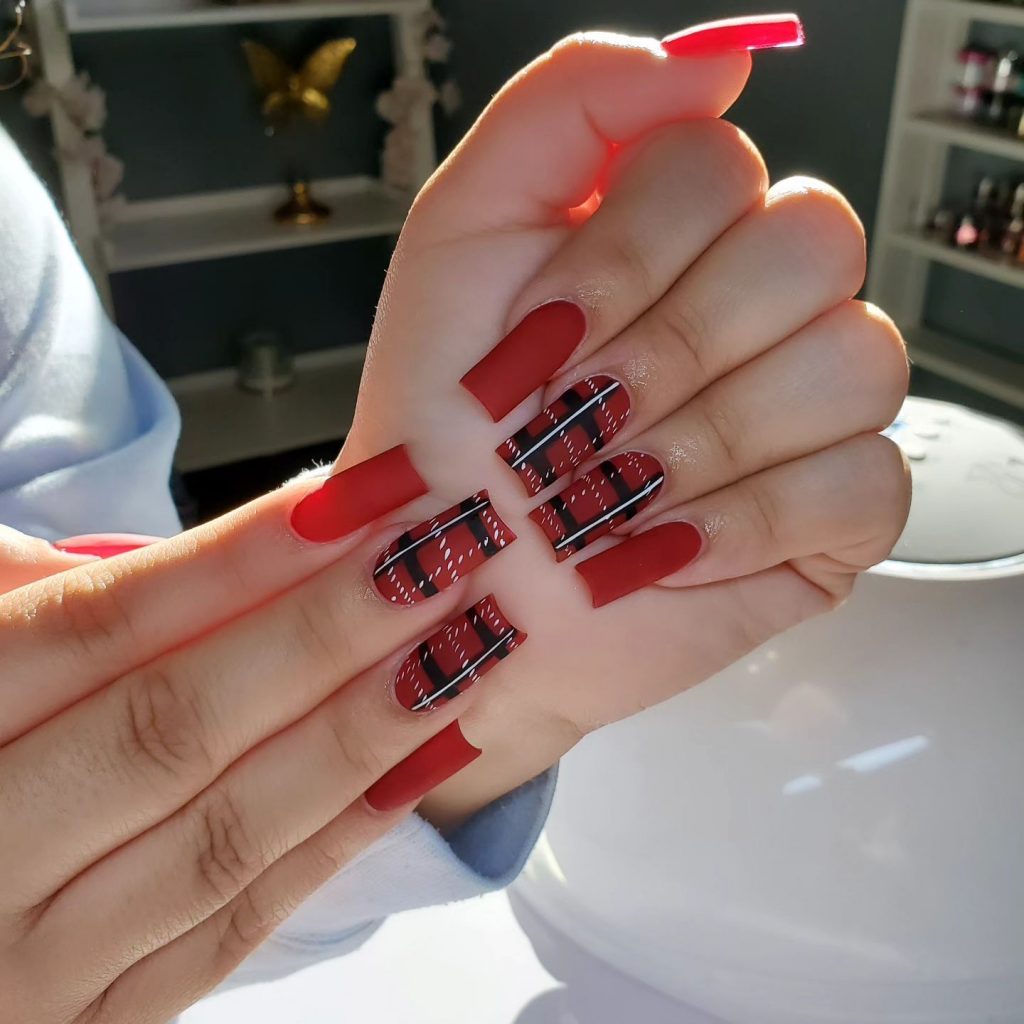 Rebellious red tartan flair on acrylic nails.