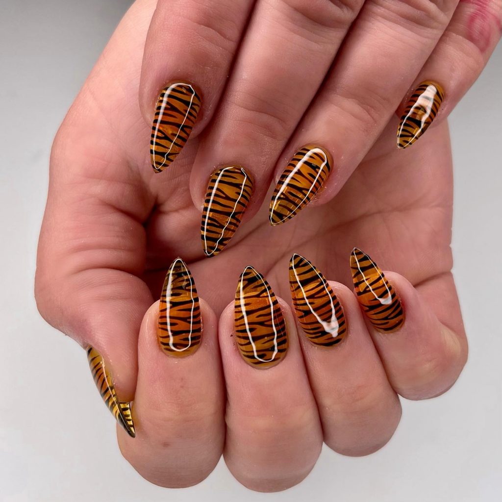 Wild tiger print nails for a fierce party style.