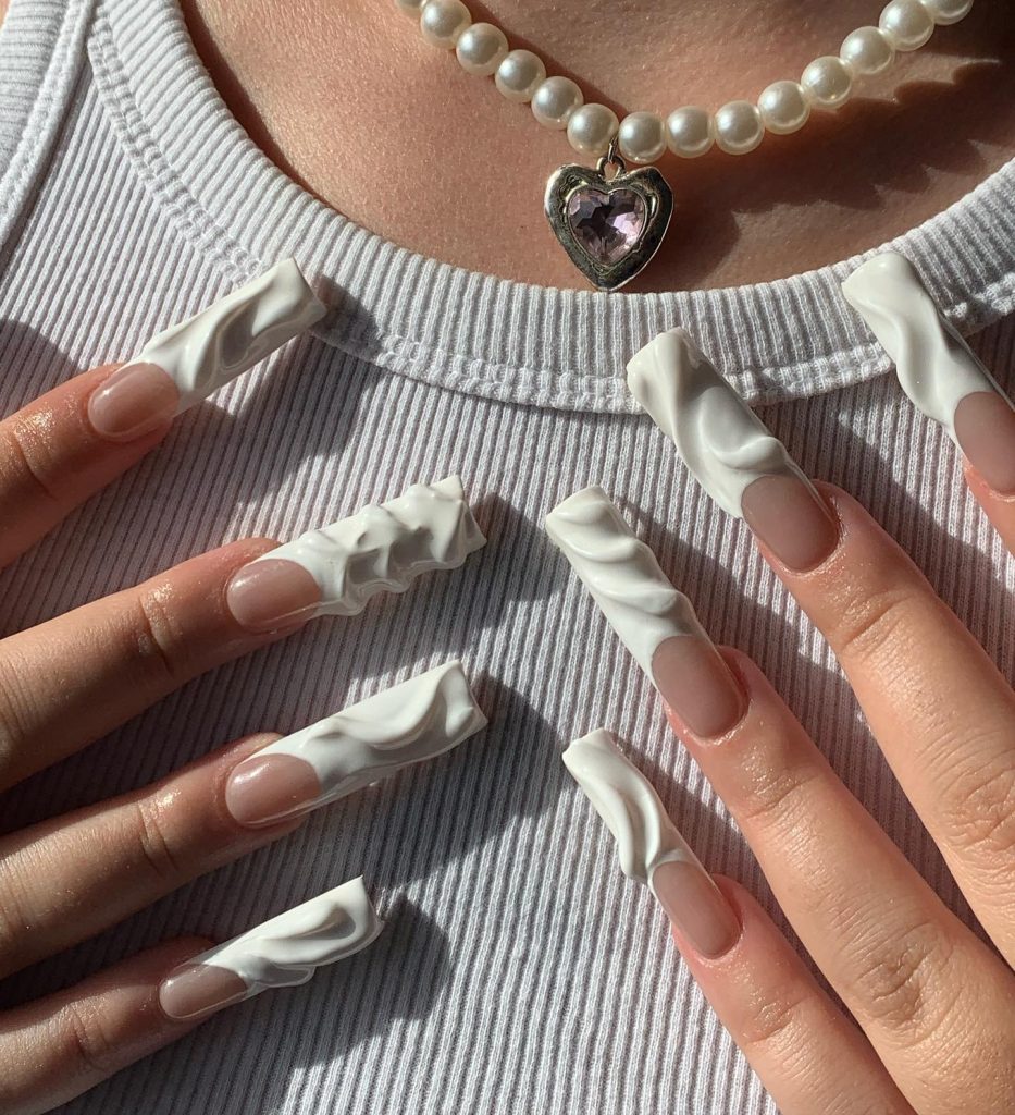 Textured white French tip nails party style.