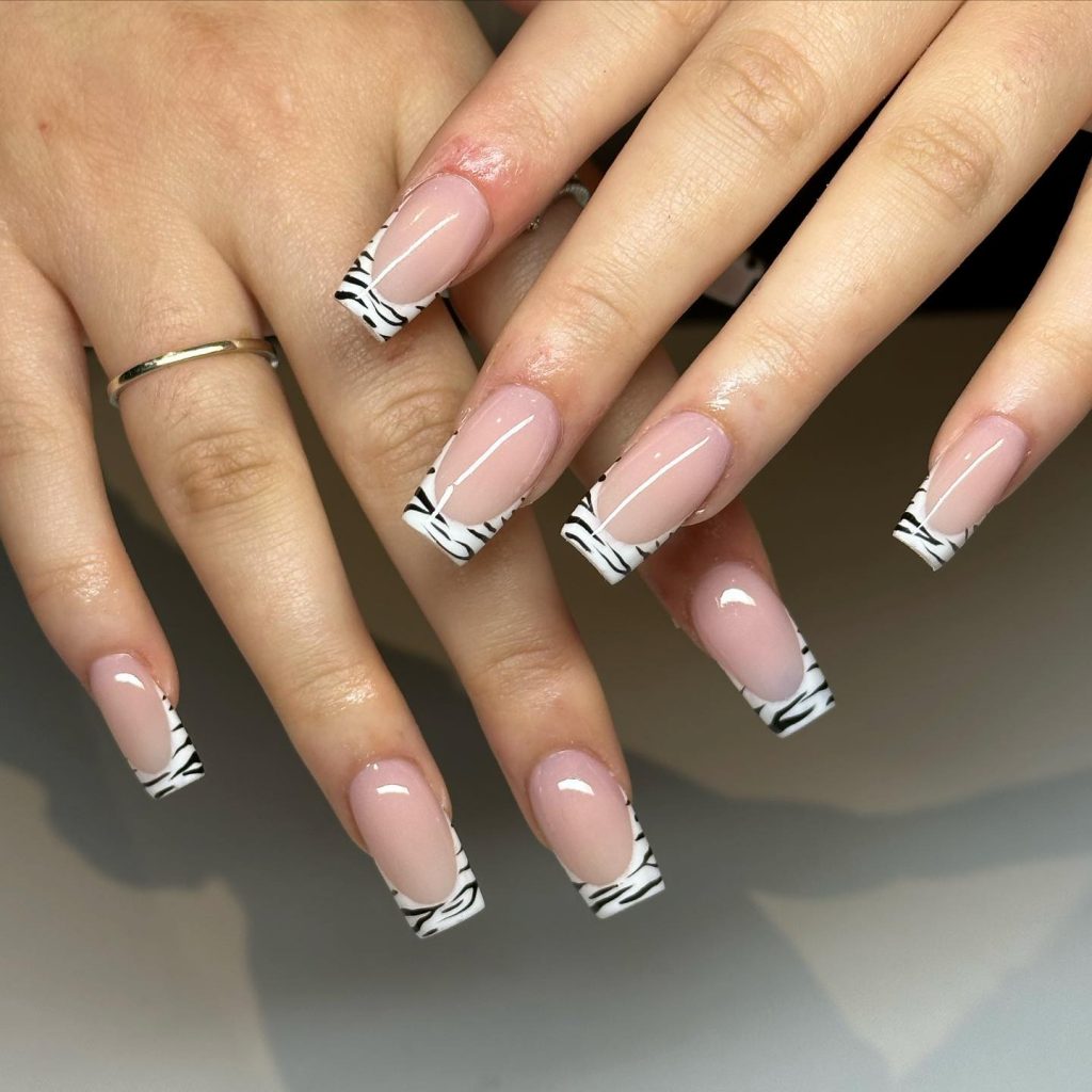 Wild zebra print sophistication on acrylic nails.