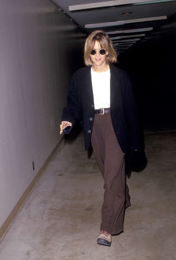 Solid black overcoat with brown trousers, 90s elegance.