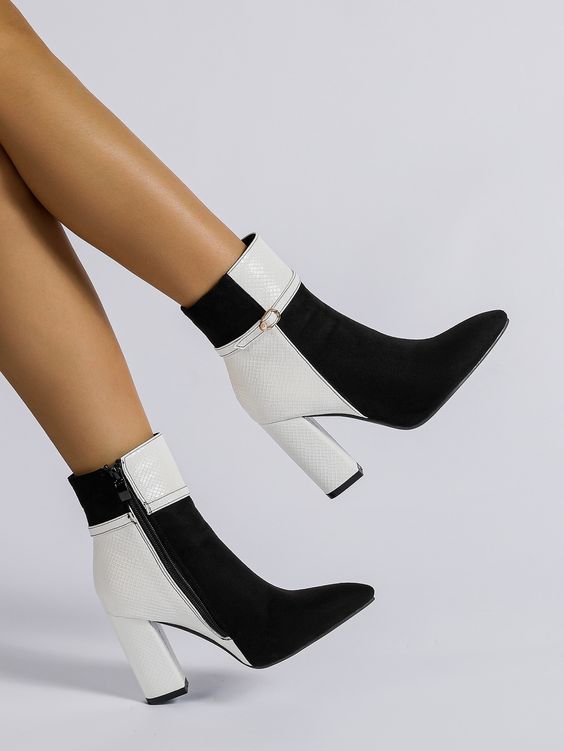 Fashion-forward geometric embossed chunky-heeled black and white boots.