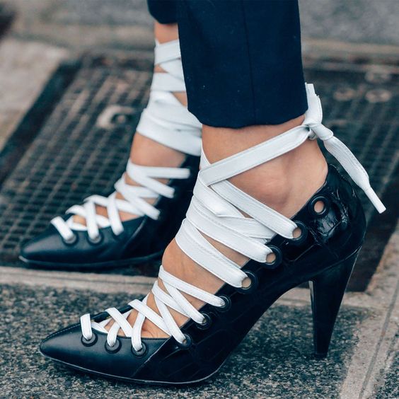 Lace-up cone heel pumps in classic black and white.