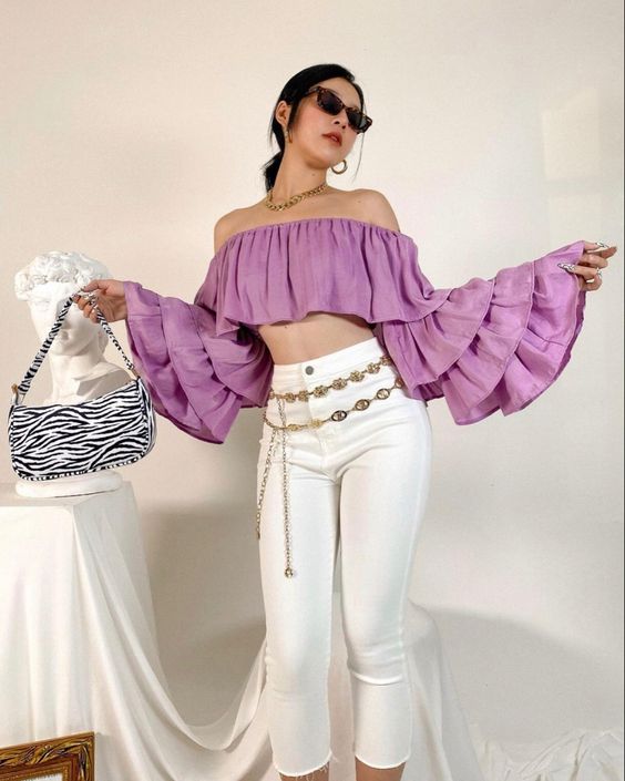 Lavender off-shoulder crop top with ruffled layered sleeves.