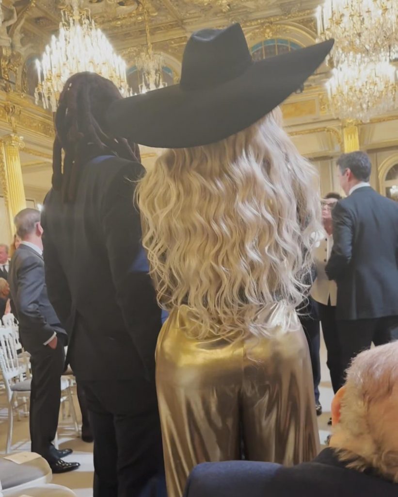Wavy blonde hair falling from under the cowboy hat
