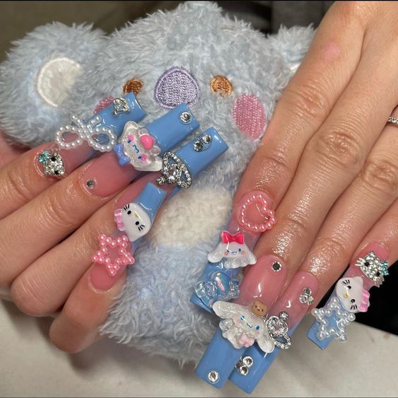 acrylic nail manicure with added Hello Kitty charms 