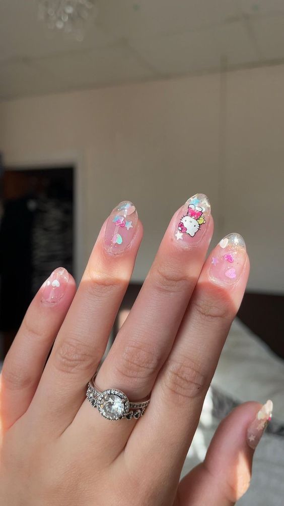 clear graffiti oval nails with Hello Kitty decals 