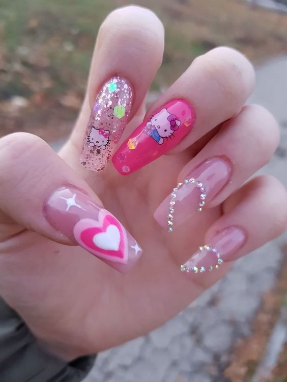 love-themed kitty manicure with rhinestones embellishment