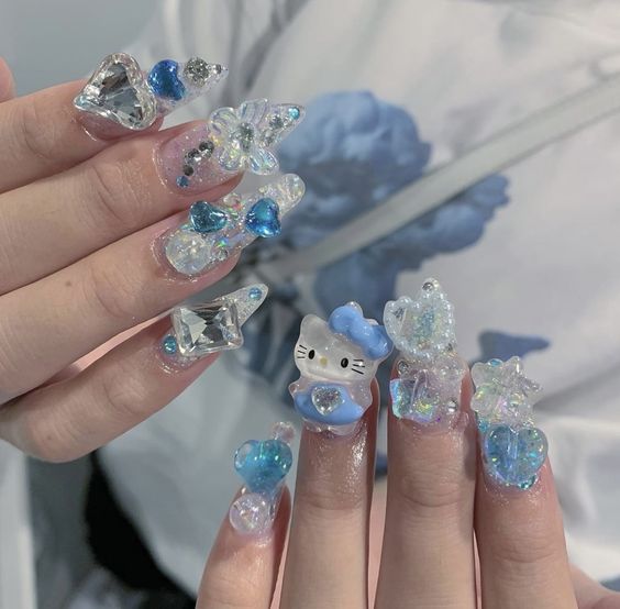 short studded hello kitty nails in blue and silver